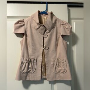 Vintage women’s tailored top with ruffle details.